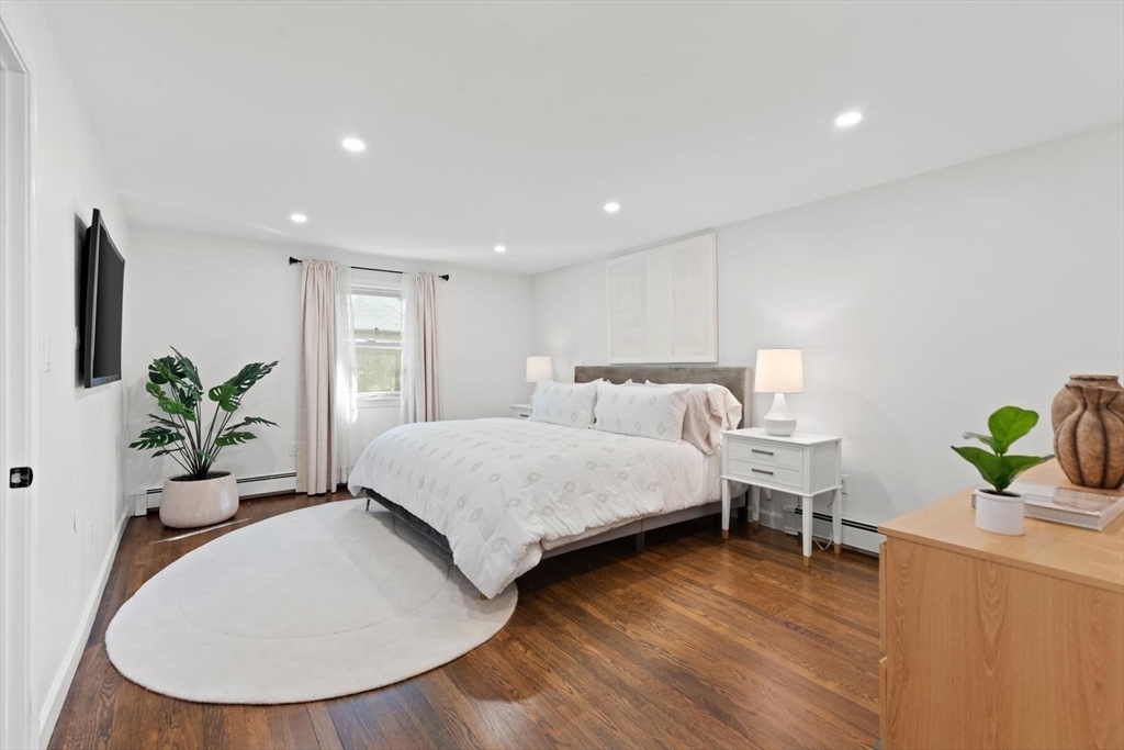 5 Alpine Circle Wakefield, MA 01880 - Photo 30 of 42 a spacious bedroom with a bed and a potted plant