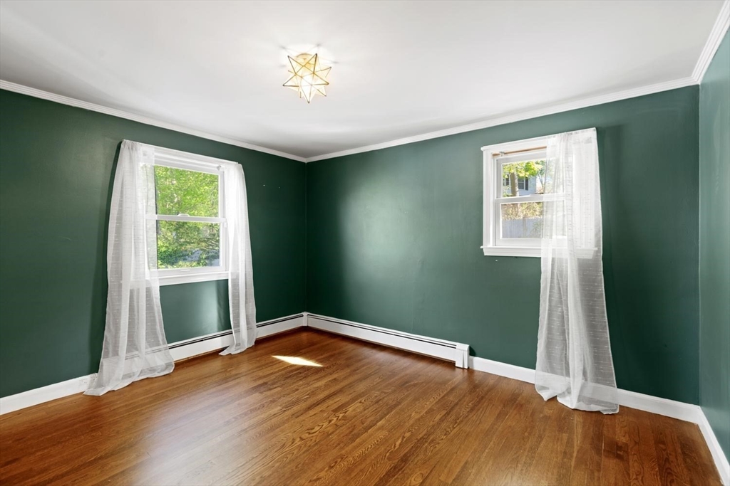 5 Alpine Circle Wakefield, MA 01880 - Photo 35 of 42 an empty room with wooden floor and windows