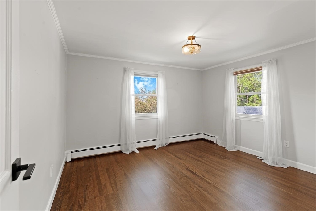5 Alpine Circle Wakefield, MA 01880 - Photo 36 of 42 an empty room with wooden floor chandelier and windows