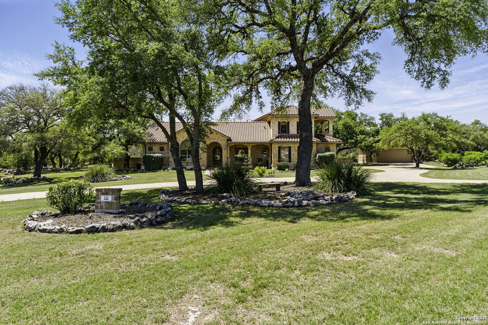 211 Macaw Lane Spring Branch, TX 78070 - Photo 2 of 85 a view of a house with a garden and trees