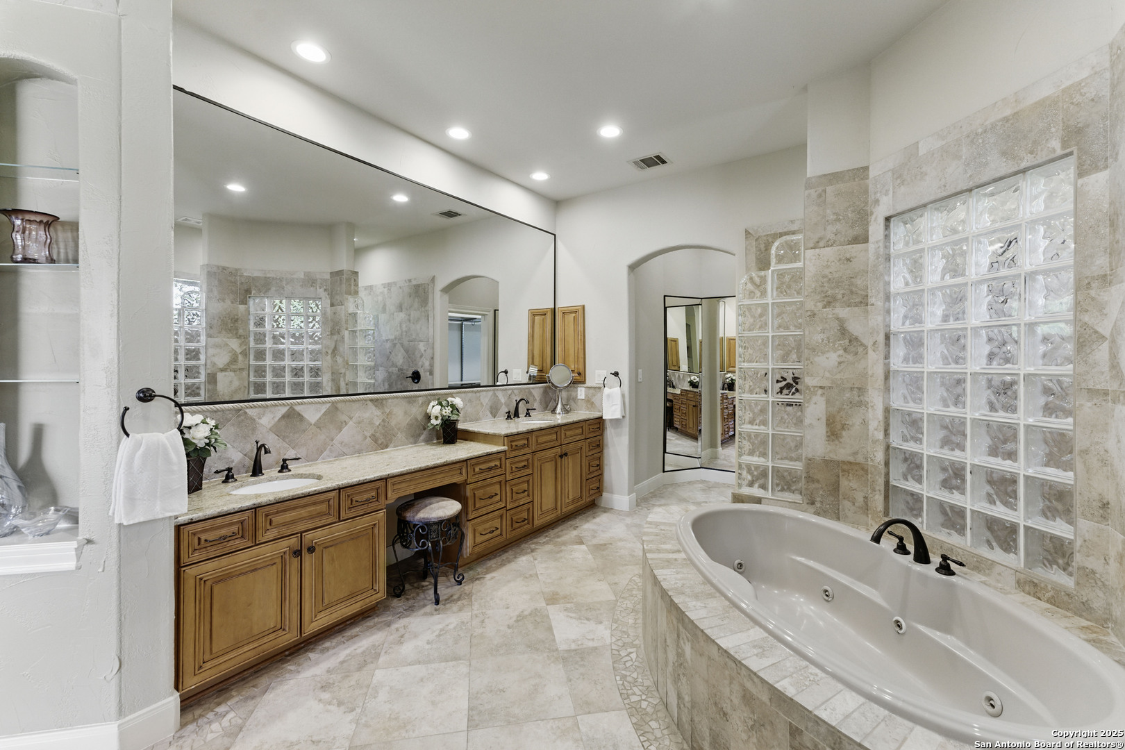 211 Macaw Lane Spring Branch, TX 78070 - Photo 22 of 85 a bathroom with a granite countertop double vanity sink a mirror and a bathtub