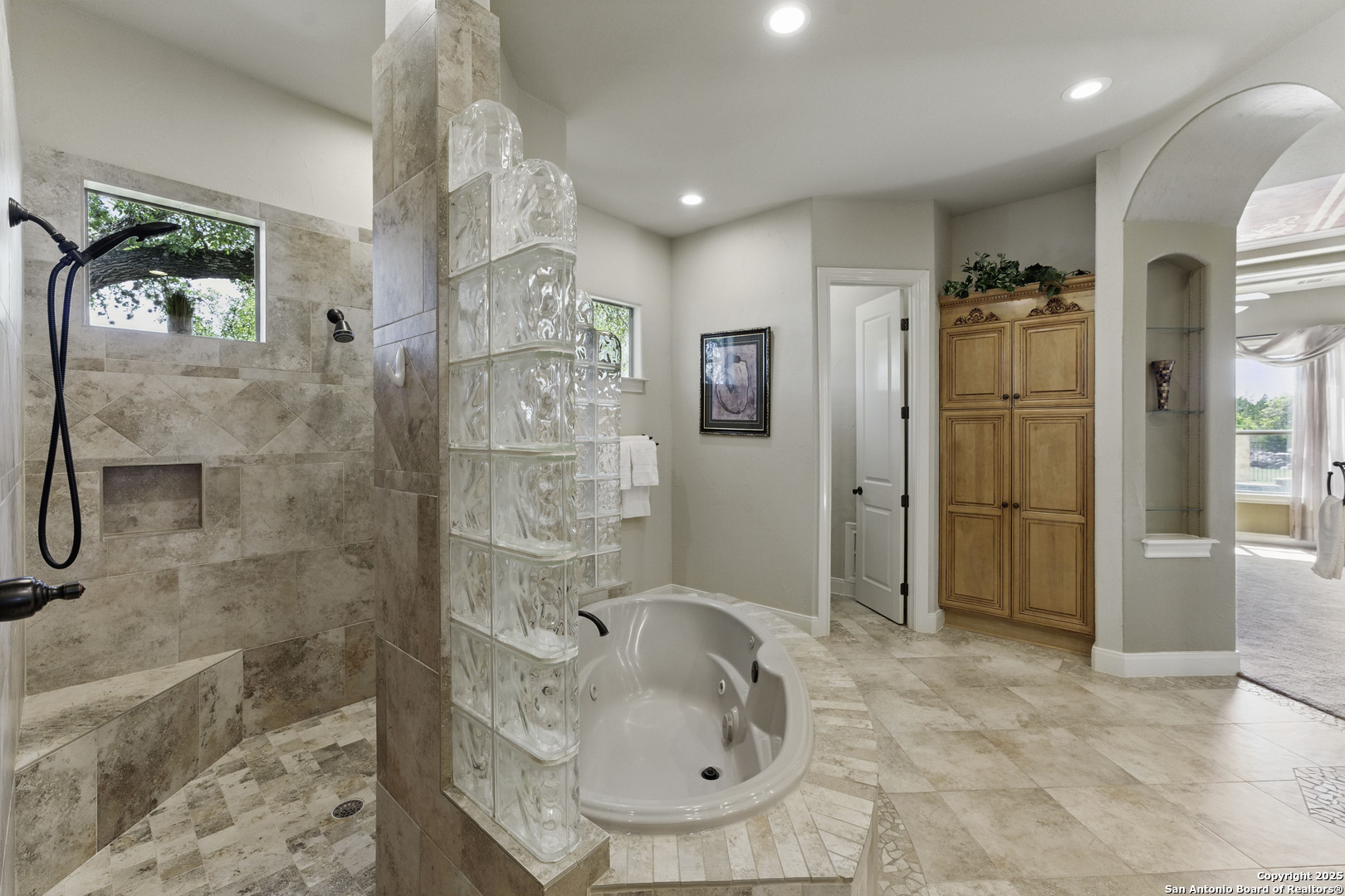 211 Macaw Lane Spring Branch, TX 78070 - Photo 24 of 85 a bathroom with a granite countertop sink a mirror and shower
