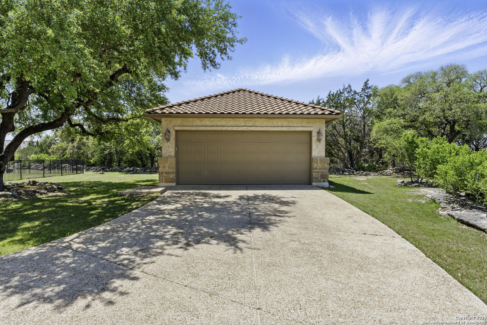 211 Macaw Lane Spring Branch, TX 78070 - Photo 5 of 85 a front view of a house with a yard and garage