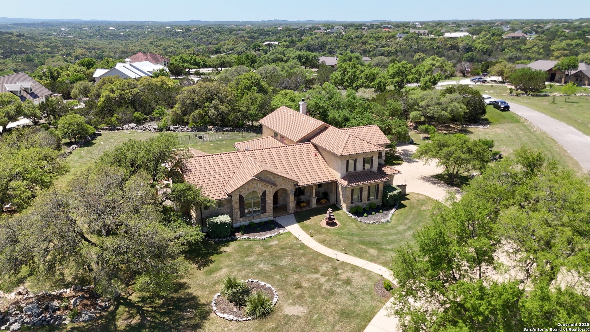 211 Macaw Lane Spring Branch, TX 78070 - Photo 63 of 85 an aerial view of a house with yard swimming pool and lake view