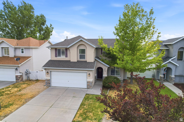 5485 Heather Way Tooele, UT 84074 - Photo 6 of 41 Two-story residence featuring a two-car garage with stone veneer accents