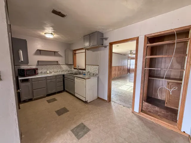 a kitchen with stainless steel appliances a refrigerator and a sink