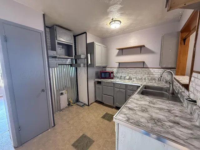 a kitchen with a sink stove and refrigerator