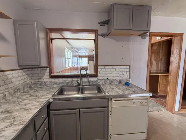 a kitchen with a sink and a refrigerator