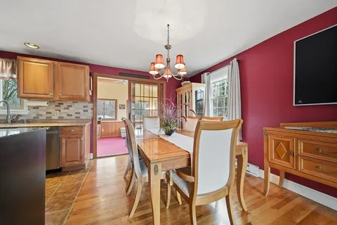 a view of a dining room with furniture wooden floor and chandelier
