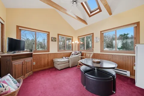a living room with furniture and a floor to ceiling window