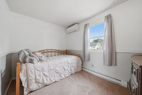 a bed room with a bed and a mirror