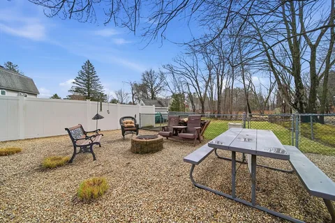 a view of a house with a yard and sitting area