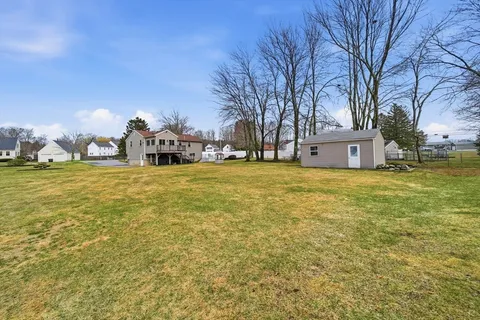 a backyard of a house with a large tree