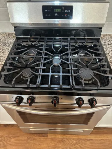 a kitchen with a refrigerator and a stove