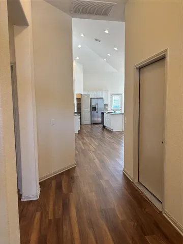 a view of a kitchen with wooden floor and a sink