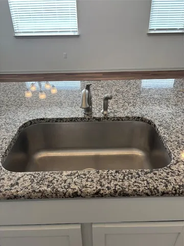 a kitchen with a stove and white cabinets
