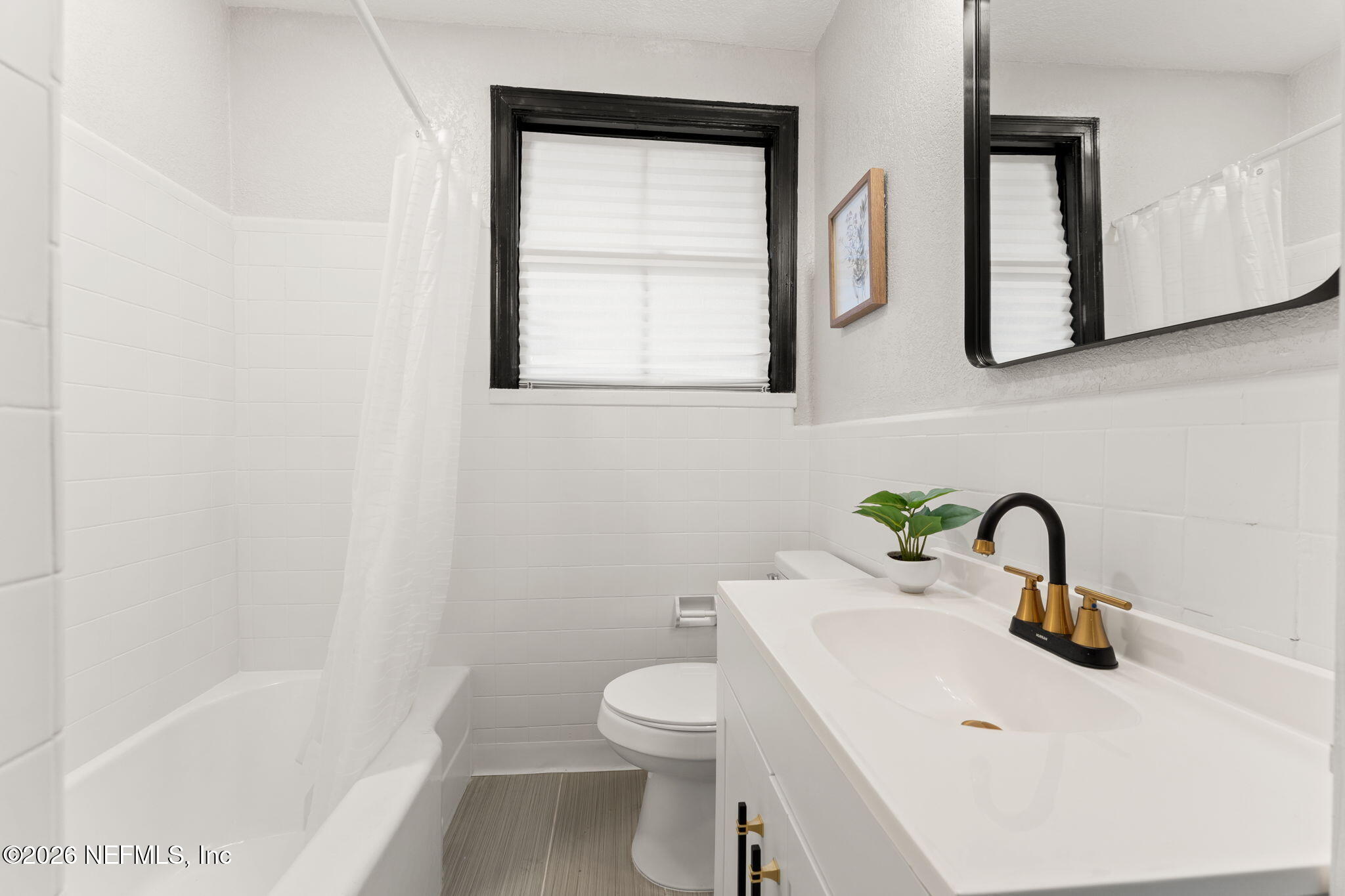 2131 Redfern Road Jacksonville, FL 32207 - Photo 12 of 13 a bathroom with a toilet sink and mirror