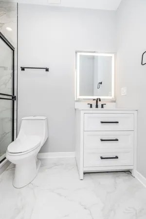 a bathroom with a sink a toilet and a mirror