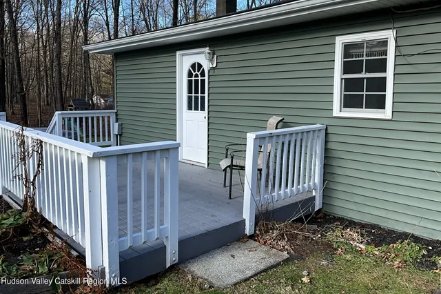 a living room with furniture a air conditioner vent and a window