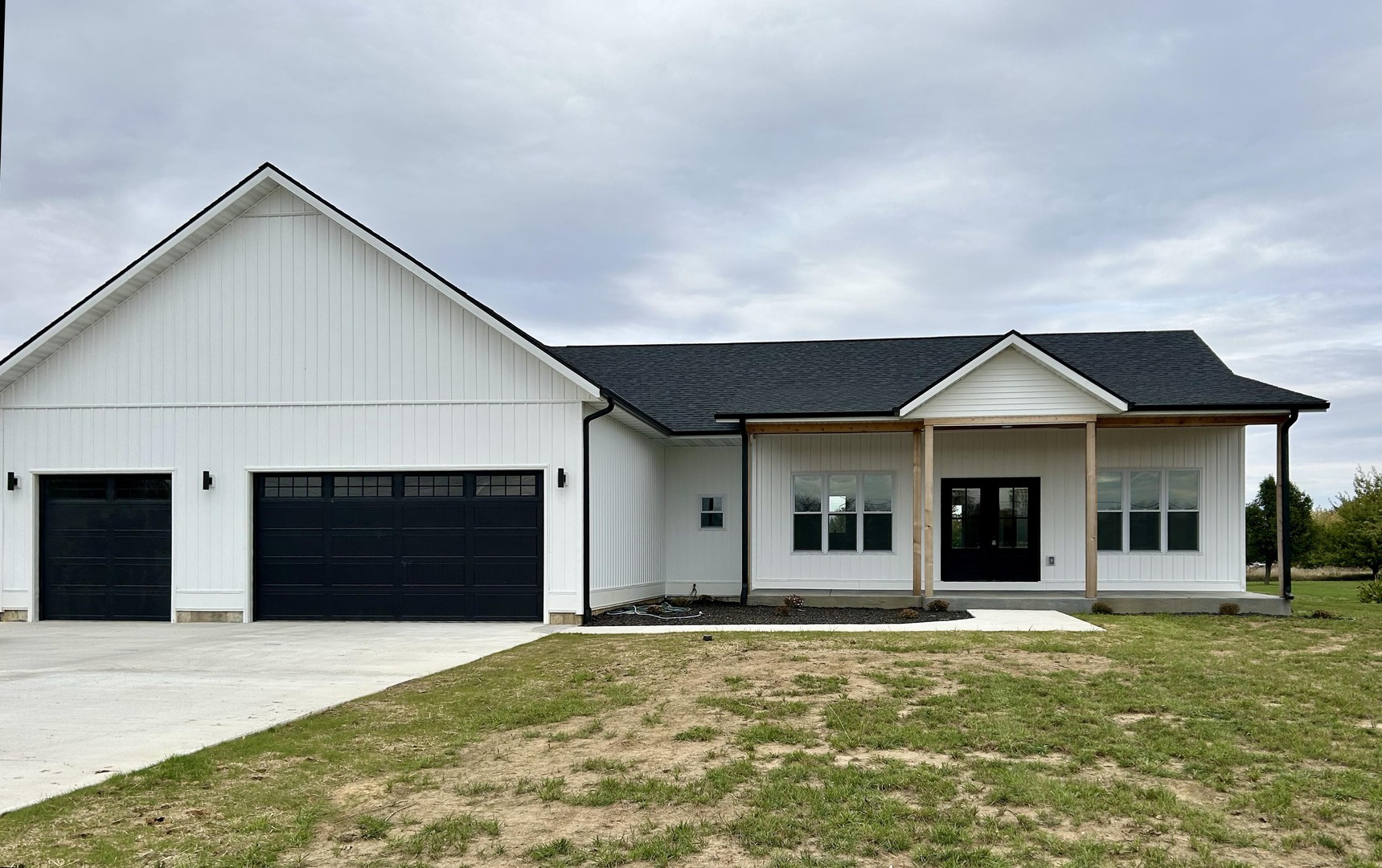 a view of a house with a yard and garage