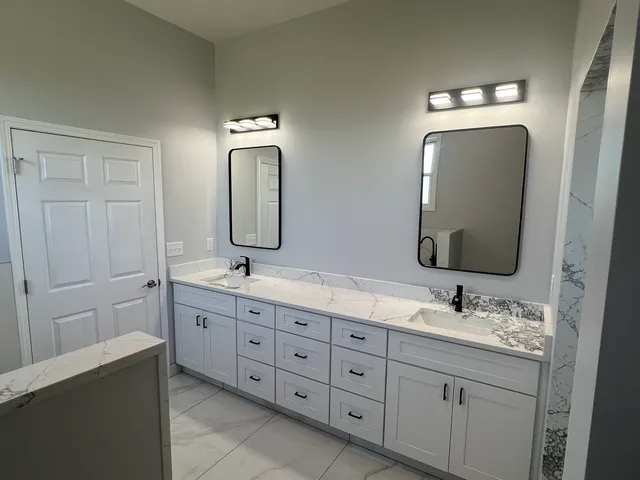 a bathroom with a double vanity sink and a mirror