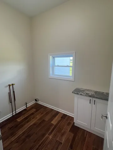 a view of a room with wooden floor and fan