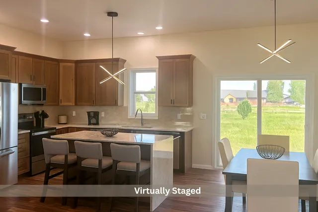 a kitchen with a table chairs refrigerator and microwave