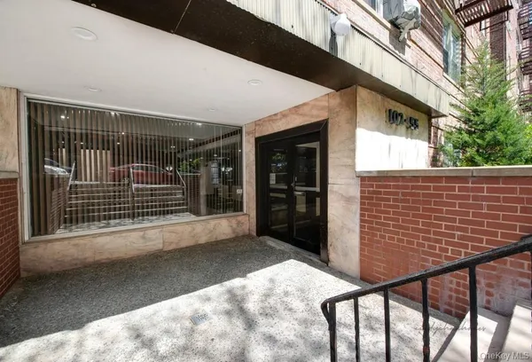 a view of a room with gym equipment and large window