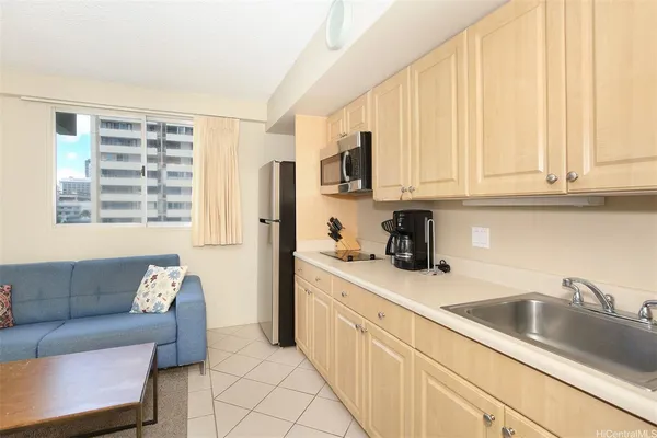 a kitchen with stainless steel appliances granite countertop a sink and a white cabinets