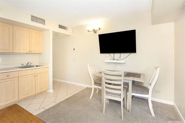 a dining room that has a chair and a flat screen tv