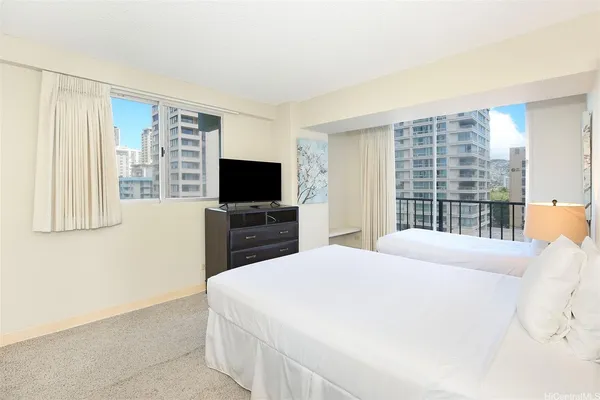 a bedroom with a bed and a flat screen tv