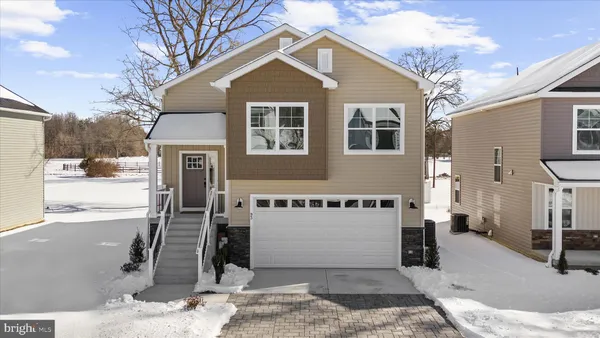 a view of a house with wooden fence