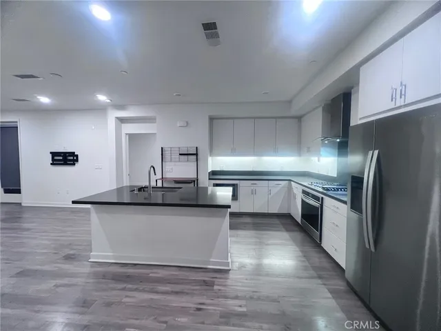 a large kitchen with stainless steel appliances granite countertop a large counter top and a stove