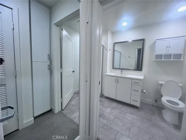 a spacious bathroom with a toilet sink and mirror