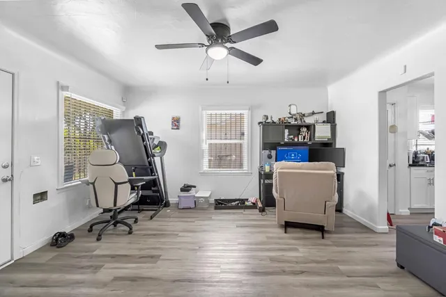 a view of a workspace with furniture and a window