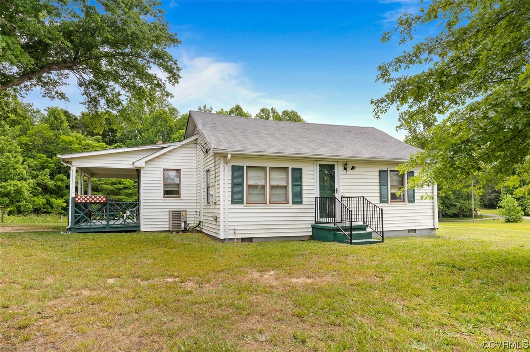 3980 Cedar Plains Road Sandy Hook, VA 23153 - Photo 1 of 18 a front view of a house with a garden