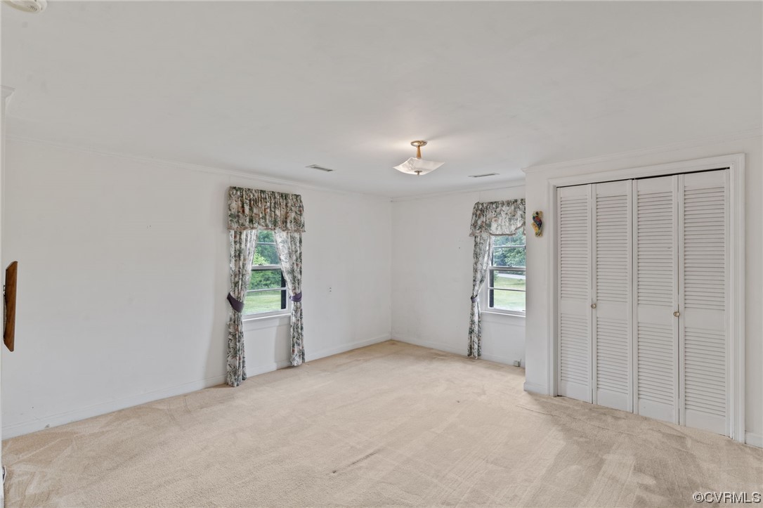 3980 Cedar Plains Road Sandy Hook, VA 23153 - Photo 11 of 18 an empty room with windows and closet