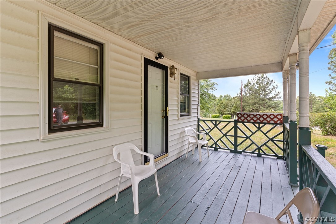 3980 Cedar Plains Road Sandy Hook, VA 23153 - Photo 3 of 18 a view of a chairs on the deck