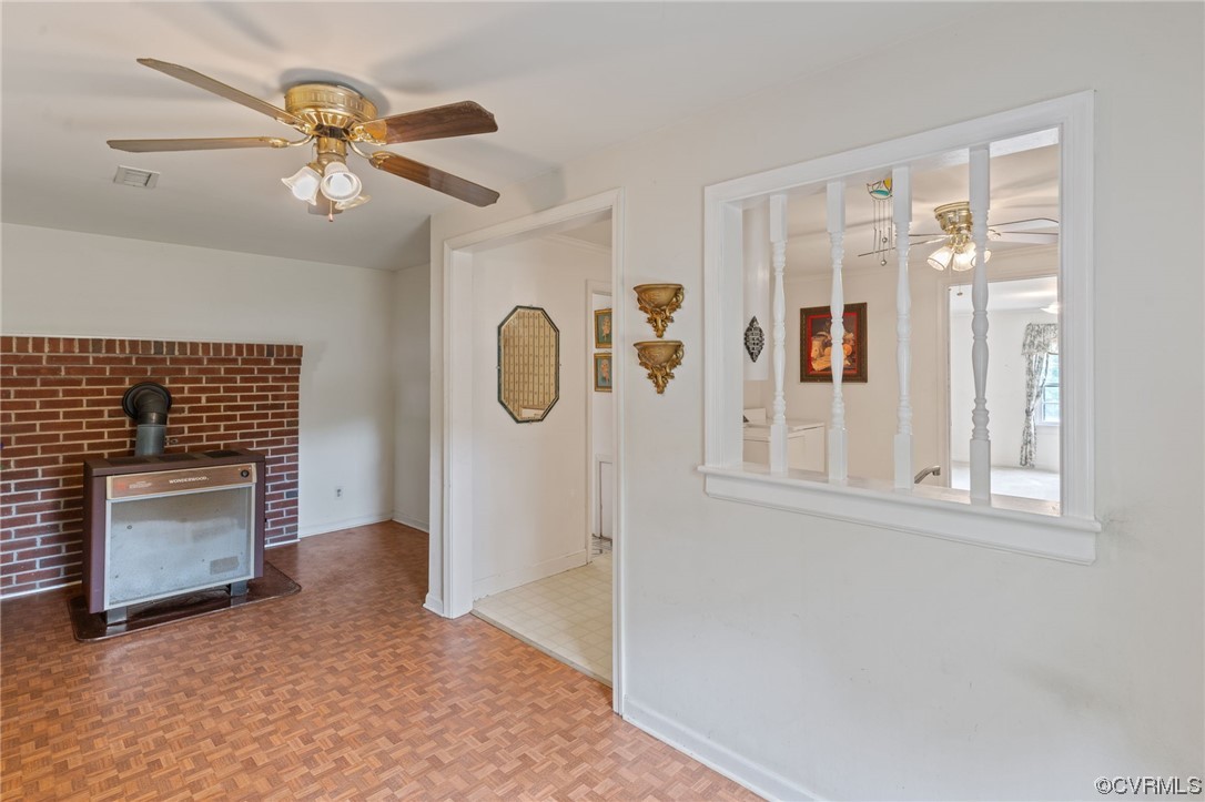 3980 Cedar Plains Road Sandy Hook, VA 23153 - Photo 6 of 18 wooden floor with chandelier fan and fire place