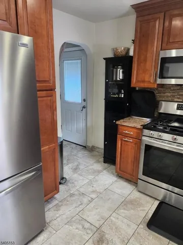 a kitchen with a refrigerator and a stove