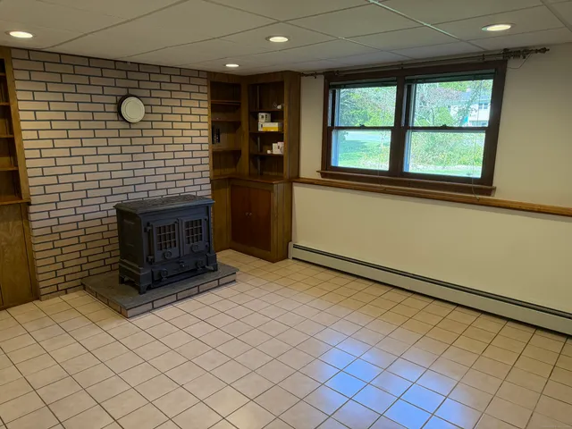 a view of an empty room with a fireplace