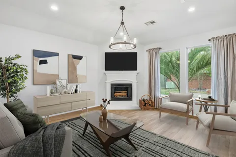 a living room with furniture fireplace and a flat screen tv
