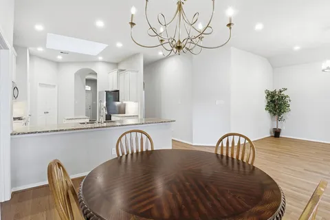 a view of a dining room with furniture and chandelier