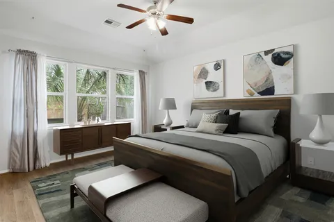 a bedroom with a bed and wooden floor