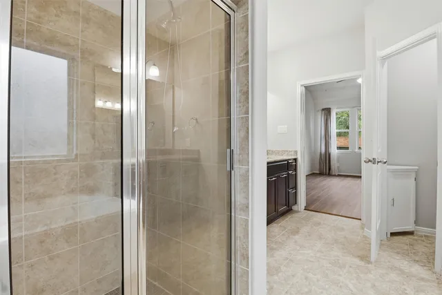 view of a bathroom with a walk in closet and a bathroom