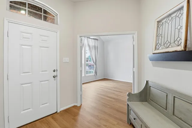a view of an entryway with wooden floor