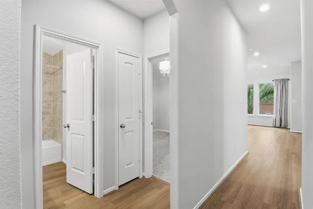 a view of a hallway with wooden floor