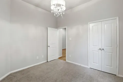 a view of an empty room with a chandelier
