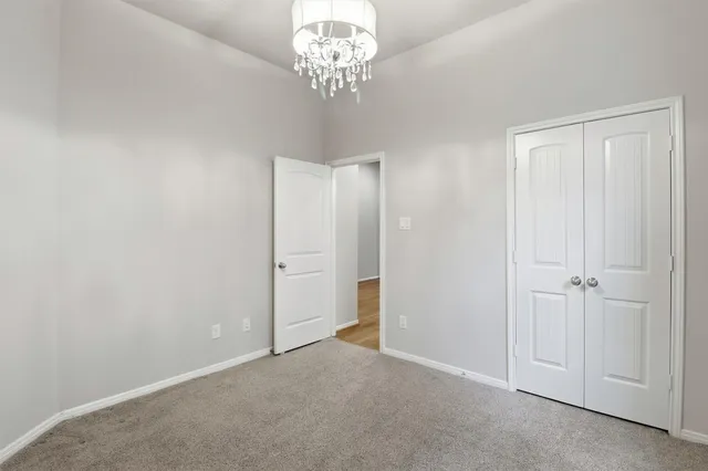a view of an empty room with a chandelier
