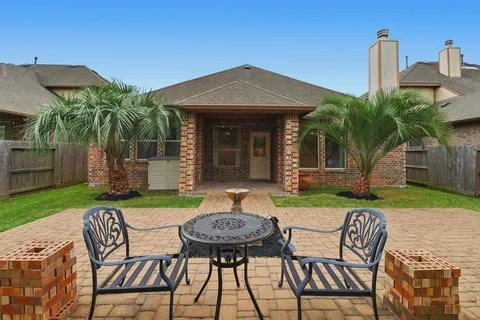 a view of a table and chairs in patio with a yard